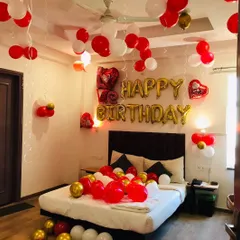 A simple yet beautiful birthday room surprise. We used red, white, and gold balloons on the ceiling and bed, along with foil "Happy Birthday" letters, to create a festive and romantic atmosphere.