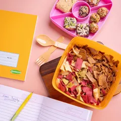 Tiffin time made easier for moms and happier for kids. This image shows a variety of my snacks, including baked chips and traditional sweets, packed neatly in lunchboxes.