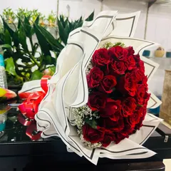 Another popular style for a red rose bouquet, using modern striped paper and a touch of baby's breath. I can customize the wrapping based on your preference.