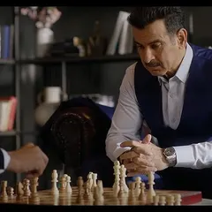 A screengrab from the final ad, showing the complete look in action. The tailored three-piece suit was chosen to convey a sense of strategy and success, fitting the theme of the commercial.