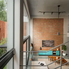 From the upper level, you can appreciate the scale of the double-height living space and its connection to the garden. The open staircase maintains a sense of lightness, ensuring views are unobstructed throughout the home.