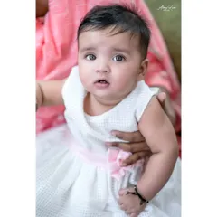 A sweet portrait of Navya in a lovely white dress. Sitter sessions often include multiple outfit changes to add variety to the final gallery.