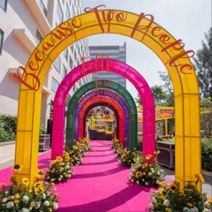 For a modern and playful Mehandi, we created this colorful archway entrance. The rainbow-hued arches with custom text set a fun, celebratory tone from the moment guests arrive.