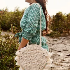 Here's another look at my bohemian fringe magic bag, worn as a shoulder bag. It's perfect for a vacation or a day out with friends. The intricate knotting and tassel details really stand out, and it's made from 100% eco-friendly cotton.
