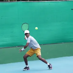 Generating power from the ground up. This photo captures the dynamic balance and core rotation we teach for powerful groundstrokes during a match-play scenario.