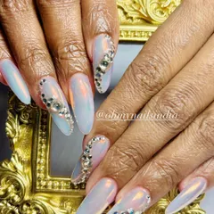 Client-favorite chrome nails with a touch of bling. This design features an iridescent chrome base with accent nails covered in sparkling silver crystals.