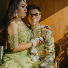 A regal portrait of a couple during their Haldi ceremony, with the afternoon sun casting a beautiful warm light on them.