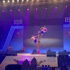 Another dynamic shot from our stage performance in Ahmedabad. The combination of athletic poses and dramatic lighting created a memorable spectacle for the audience.