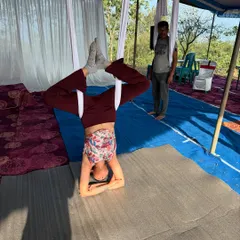 A throwback to an aerial yoga workshop in Attapadi, Kerala. Here, a participant is supported by the silk in a forearm headstand, building confidence in inversions.