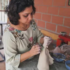 Here I am, working on a figurative sculpture. It's a slow and meditative process of shaping and refining the clay.