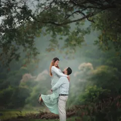 A classic, romantic lift captured in the soft, diffused light of a misty morning. The lush green surroundings and the gentle interaction between the couple create a dreamy and timeless pre-wedding portrait.