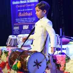 One of our youngest performers, Aviraj Singh, confidently takes the stage with a dhol. We welcome students of all ages, nurturing talent from the very beginning and providing them with opportunities to perform.