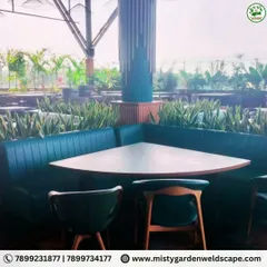 We integrated low-maintenance snake plants as a natural divider behind the seating booths at Skydeck, adding a touch of green that enhances the dining experience without obstructing the view.