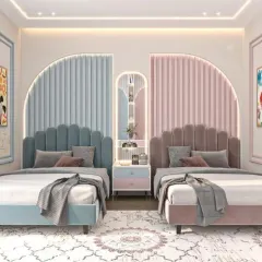 A playful yet elegant shared room featuring scalloped headboards in blue and pink. The design is perfectly symmetrical, with a shared central nightstand, creating a balanced and visually pleasing space for siblings.