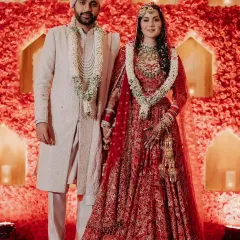 A classic red and ivory theme brought to life with a stunning wall of red roses as the mandap backdrop. This design combines traditional wedding colors with a modern, impactful floral statement for a timeless look.