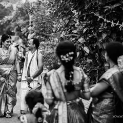 A candid, street-style black and white shot of a family walking during an event. This documentary approach allows us to capture the natural flow and atmosphere of your celebration.