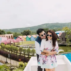 A happy, relaxed photo overlooking the entire studio set. This shot shows the variety of backdrops available, from colorful huts to lush greenery.
