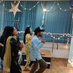 Another candid shot from our Diwali celebration, showing guests enjoying the festive atmosphere. The studio provides a private and comfortable setting for your friends and family to gather.