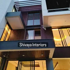 This is a closer look at the detailing on a modern facade project. You can see the clean lines of the dark brown cladding and how it integrates with the building's structural elements and window frames for a cohesive finish.