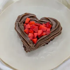A mini heart-shaped treat for your love. This dessert features a rich chocolate base filled with freshly chopped strawberries and piped with a border of creamy Nutella frosting.