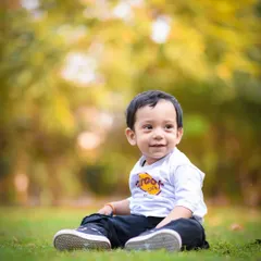 A simple, happy portrait of a little boy enjoying a sunny day in the park. Sometimes the most beautiful photos are the most natural ones.
