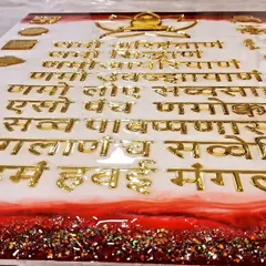 A Navkar Mantra frame in the making during a workshop. Here, my student is carefully placing the golden acrylic letters onto the resin base, creating a piece full of devotion.