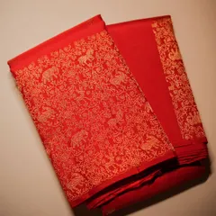 The full view of the red Kanjivaram, folded to display the dense, all-over zari work on the pallu, a hallmark of a true bridal masterpiece.