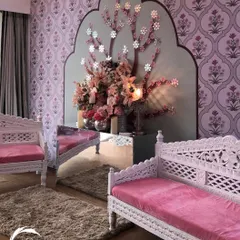 For a more traditional yet elegant feel, I used Rajasthani-inspired block-print wallpaper and intricately carved white wooden seating. The floral tree art piece adds a touch of modern whimsy.