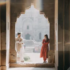 Using the beautiful architecture of Lodhi Garden in Delhi to frame a quiet moment. The rays of light add a magical, cinematic quality to this pre-wedding photo.