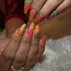 Celebrating Holi with a splash of color. These nails feature a vibrant, multi-colored base with a textured, snakeskin-like effect, perfectly capturing the joyful and playful spirit of the festival.