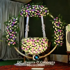 A stunning cradle decorated with a cascade of fresh flowers. This beautiful floral arrangement creates a perfect, fragrant nest for the baby during their naming ceremony.