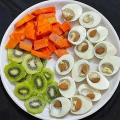 A perfect example of a nutrient-dense snack. Hard-boiled egg whites with almonds and cashews for protein and healthy fats, paired with fresh kiwi and carrots for vitamins.