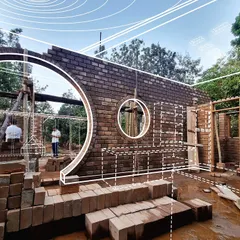 A visualization overlayed on a construction photo of project 'FM-177'. This shows how the initial design intent, with its circular openings and brick walls, is translated into reality on site.