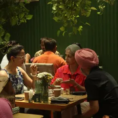 Guests engaged in conversation over a meal. For me, the magic happens when people connect and share stories around the dining table.