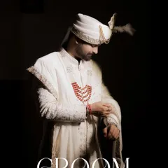 A powerful, full-length portrait of the groom against a dark background. The word 'GROOM' is elegantly overlaid, making this a definitive and timeless image from his wedding day.