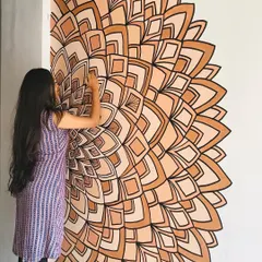 I love working with earthy, monochrome palettes. This half mandala mural uses shades of brown to create a warm and inviting corner piece that feels both modern and traditional.