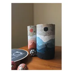 This image showcases two of my 'Mystic Mountains' sculptures side by side. I transform discarded concrete core cuts from construction sites into unique art objects, each hand-painted with a different landscape. It is my way of giving waste a new, beautiful life.
