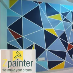 A vibrant geometric wall mural with a triangular pattern in multiple shades of blue, yellow, and red. This type of precision painting is perfect for a modern home, office, or cafe.
