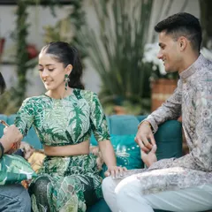 A jungle safari-themed Mehendi. The bride is wearing a unique green printed lehenga, and her makeup is kept natural and glowing to match the fun, outdoor vibe.
