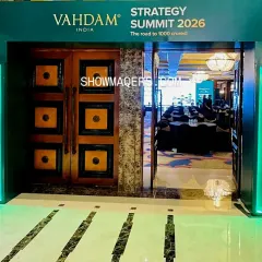 The journey into the main event hall should build anticipation. This branded entrance for the Vahdam Summit, featuring illuminated side panels, guides attendees from the reception area into the conference hall.