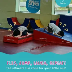 Flip, jump, laugh, repeat. Two children practice forward rolls on wedge mats, a foundational gymnastics skill that teaches body control and spatial awareness in a safe way.