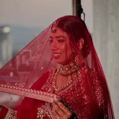 A beautiful, candid moment under the veil. The soft lighting catches the glow on her skin, showing how the makeup looks just as good in motion as it does in posed photos.