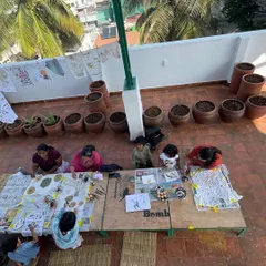 An overhead view of an art session in progress. Our large work tables and open layout allow for collaborative projects and give everyone enough space to spread out and create.