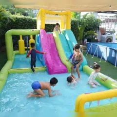 Making a splash at one of our signature pool parties. Our outdoor area transforms into a mini water park with inflatable slides and pools, perfect for beating the heat and creating unforgettable summer memories.