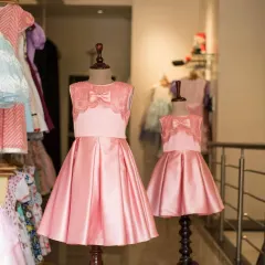 A view of the matching pink satin dresses from my studio. Creating identical pieces in different sizes is one of my favorite ways to help sisters celebrate their connection.