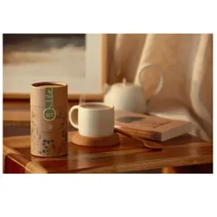 A lifestyle scene connecting the tea brand with relaxation and quiet moments. The composition includes a book and warm lighting to build a narrative of comfort and peace.