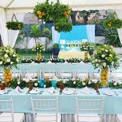 A vibrant Tuscan-style luncheon for a 50th birthday celebration. I used hanging citrus plants and fresh floral centerpieces to create a sunny, Mediterranean feel for this milestone event.