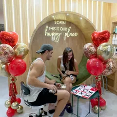 Love and a little friendly competition. A couple enjoys a game of tic-tac-toe while relaxing at the salon during a special Valentine's Day setup.