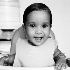 A happy smile from my little one during her first year. Learning to self-feed gave her so much independence and made introducing new foods a fun experience for both of us.