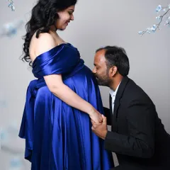 A classic and heartwarming pose. The father-to-be kissing the baby bump is a timeless expression of love and anticipation.